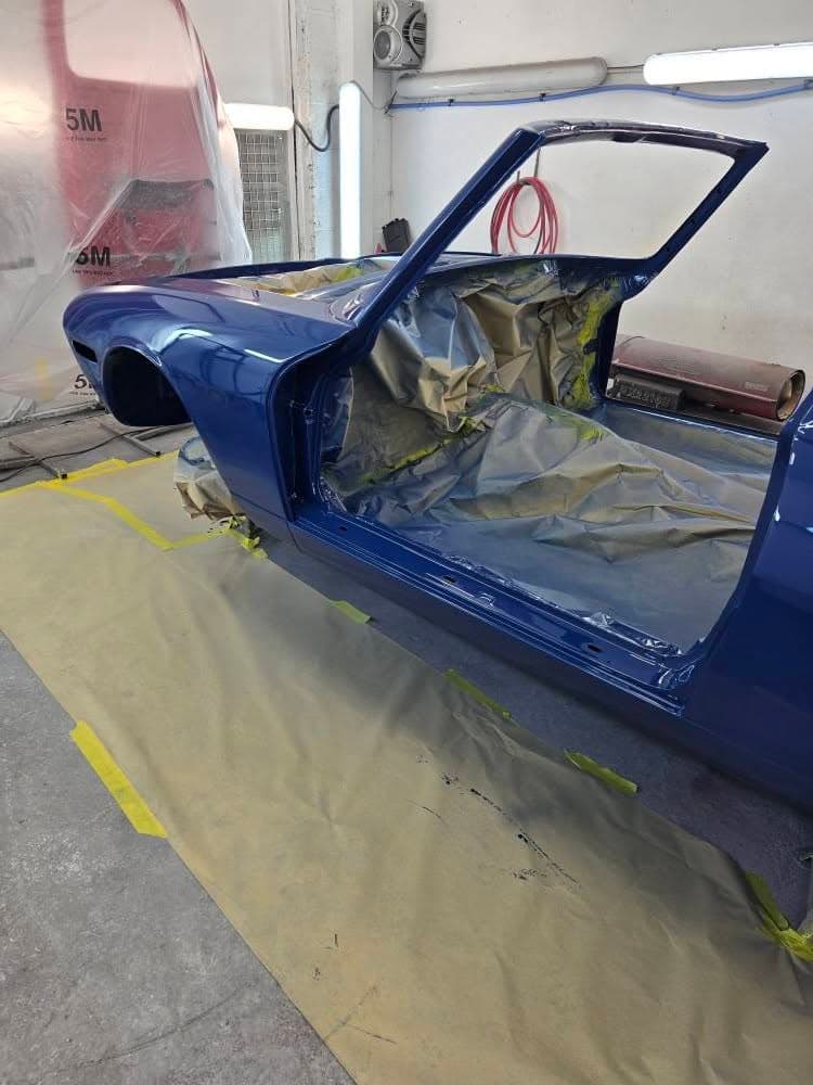 Muscle car body shell in paint booth